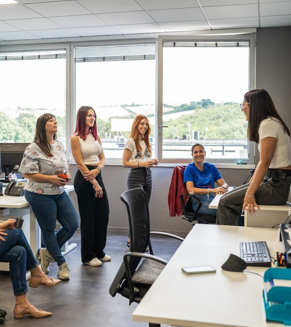 Un gruppo di persone che chiacchierano in un ufficio luminoso e moderno.